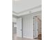 Bedroom with a tray ceiling, neutral walls and light wood flooring and 2 doors at 1461 Santorini Way, Tavares, FL 32778