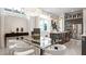Contemporary dining area featuring a glass table, stylish chairs, and modern lighting fixtures at 1461 Santorini Way, Tavares, FL 32778