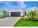 Beautiful one-story home showcasing a well-manicured lawn and a neutral-toned exterior at 1461 Santorini Way, Tavares, FL 32778