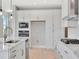 Modern kitchen featuring a large island, stainless steel appliances, and bright white cabinetry at 1461 Santorini Way, Tavares, FL 32778