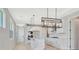 Beautiful kitchen with white cabinets, hardwood floors, and modern lighting fixtures at 1461 Santorini Way, Tavares, FL 32778