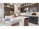 Stylish kitchen with an island, stainless steel appliances, and unique backsplash at 1461 Santorini Way, Tavares, FL 32778