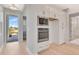 Kitchen area with stainless steel appliances including a microwave and oven, and white cabinetry at 1461 Santorini Way, Tavares, FL 32778