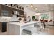 Modern kitchen with sleek cabinets, a white quartz island, and stainless steel appliances at 1461 Santorini Way, Tavares, FL 32778