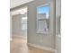 Living room with light wood floors, neutral paint and bright windows at 1461 Santorini Way, Tavares, FL 32778