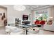 Bright, open-concept living room with modern glass dining table, comfortable seating, and large windows to provide natural light at 1461 Santorini Way, Tavares, FL 32778