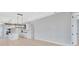 Open living space featuring hardwood floors, white cabinets, an island, and a modern light fixture at 1461 Santorini Way, Tavares, FL 32778