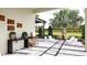 Outdoor living area with modern seating, lush landscaping, and a serene atmosphere, perfect for relaxation at 1461 Santorini Way, Tavares, FL 32778