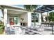 Spacious covered patio with modern seating, outdoor dining, and open access to the outdoors, ideal for entertaining and relaxation at 1461 Santorini Way, Tavares, FL 32778