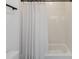 Clean bathroom featuring a shower/tub combo with white tile surround and a white shower curtain at 15408 Lebeau Loop, Winter Garden, FL 34787