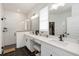 Modern bathroom with dual sinks, sleek black fixtures, and a glass-enclosed shower for a spa-like experience at 15408 Lebeau Loop, Winter Garden, FL 34787