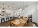 Open-concept dining area with modern pendant lights, seamlessly connecting to the kitchen and living spaces at 15408 Lebeau Loop, Winter Garden, FL 34787
