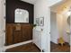 Stylish entryway with a black accent wall, vertical wooden slats, shoe storage, and a decorative arched mirror at 15408 Lebeau Loop, Winter Garden, FL 34787