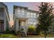 Charming two-story home with a well-maintained lawn and inviting front porch with white stairs and railing at 15408 Lebeau Loop, Winter Garden, FL 34787