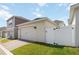 Detached garage with white fence and green grass at 15408 Lebeau Loop, Winter Garden, FL 34787