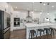 Sleek kitchen featuring stainless steel appliances, white cabinets, granite countertops, and hardwood floors at 15408 Lebeau Loop, Winter Garden, FL 34787