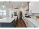 Modern kitchen featuring white cabinets, stainless steel appliances, and a large island at 15408 Lebeau Loop, Winter Garden, FL 34787