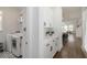 Well-lit laundry room with front-load washer/dryer and convenient counter space and cabinets at 15408 Lebeau Loop, Winter Garden, FL 34787
