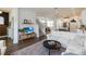 Bright living room features modern finishes and leads to the kitchen and dining area at 15408 Lebeau Loop, Winter Garden, FL 34787