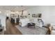 Open-concept living room featuring a white sofa, modern décor, and seamless transition to the kitchen area at 15408 Lebeau Loop, Winter Garden, FL 34787