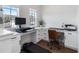 Bright office space with built-in desk areas and ample storage, complemented by natural light and a treadmill at 15408 Lebeau Loop, Winter Garden, FL 34787