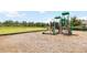 Outdoor community playground offers a fun area, a large open green field, and lush surrounding trees at 15408 Lebeau Loop, Winter Garden, FL 34787