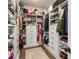 Spacious walk-in closet with custom shelving and ample storage for clothes and accessories at 15408 Lebeau Loop, Winter Garden, FL 34787