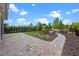 Picture of backyard with stone paver patio, grass, mulch, and landscaping at 15702 Vetta Dr, Bella Collina, FL 34756