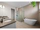 Modern bathroom with a glass shower, standalone tub, double vanity, and elegant fixtures at 15702 Vetta Dr, Bella Collina, FL 34756