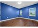 This bedroom has hardwood floors, and two windows offer natural light at 15702 Vetta Dr, Bella Collina, FL 34756