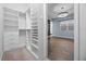 Walk-in closet with custom shelving and drawers, offering ample storage space at 15702 Vetta Dr, Bella Collina, FL 34756