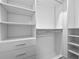 Spacious walk-in closet featuring custom shelving and ample storage space at 15702 Vetta Dr, Bella Collina, FL 34756