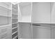 This walk-in closet has drawers, shelving, and rods for ample storage at 15702 Vetta Dr, Bella Collina, FL 34756