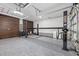 The large garage has a lift, wood paneling, and durable floor coating at 15702 Vetta Dr, Bella Collina, FL 34756