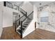 Bright and airy interior view of the stairs with hardwood floors and marble wall accents at 15702 Vetta Dr, Bella Collina, FL 34756