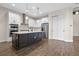 Modern kitchen with stainless steel appliances, spacious island, and bright white cabinetry at 15702 Vetta Dr, Bella Collina, FL 34756