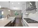 Modern kitchen showcasing stainless steel appliances, a gas range, and subway tile backsplash at 15702 Vetta Dr, Bella Collina, FL 34756