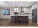 Modern kitchen featuring an island, stainless steel appliances, and ample cabinet space at 15702 Vetta Dr, Bella Collina, FL 34756