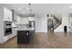 Bright kitchen features an island, stainless steel appliances, and hardwood floors at 15702 Vetta Dr, Bella Collina, FL 34756