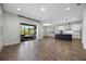 Bright living room flows into a modern kitchen with stainless steel appliances and outdoor access at 15702 Vetta Dr, Bella Collina, FL 34756