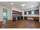 Spacious home office features wood floors, custom shelving and cabinets, and plenty of natural light from two windows at 15702 Vetta Dr, Bella Collina, FL 34756