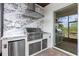 Gourmet outdoor kitchen with high-end stainless steel appliances and marble countertops at 15702 Vetta Dr, Bella Collina, FL 34756