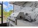 Close-up of an outdoor kitchen with stainless steel grill, marble backsplash, and sink at 15702 Vetta Dr, Bella Collina, FL 34756