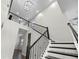 A two-story foyer features a staircase with black wrought iron railing, access to the second story, and wood floors at 15702 Vetta Dr, Bella Collina, FL 34756
