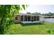 Fenced backyard with screened in porch, showing shade and foliage at 16116 Corner Lake Dr, Orlando, FL 32820