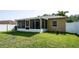 Fenced backyard with screened in porch on a sunny day at 16116 Corner Lake Dr, Orlando, FL 32820