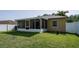 Fenced backyard with screened in porch on a sunny day, showing details at 16116 Corner Lake Dr, Orlando, FL 32820