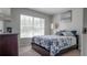 Comfortable bedroom featuring a bright window view and dark hardwood furniture at 16116 Corner Lake Dr, Orlando, FL 32820