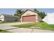 Well-maintained single-story home featuring a large two-car garage and a verdant front lawn at 16116 Corner Lake Dr, Orlando, FL 32820