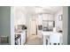 Updated kitchen with white cabinets, granite countertops, stainless steel appliances and bar top seating at 16116 Corner Lake Dr, Orlando, FL 32820